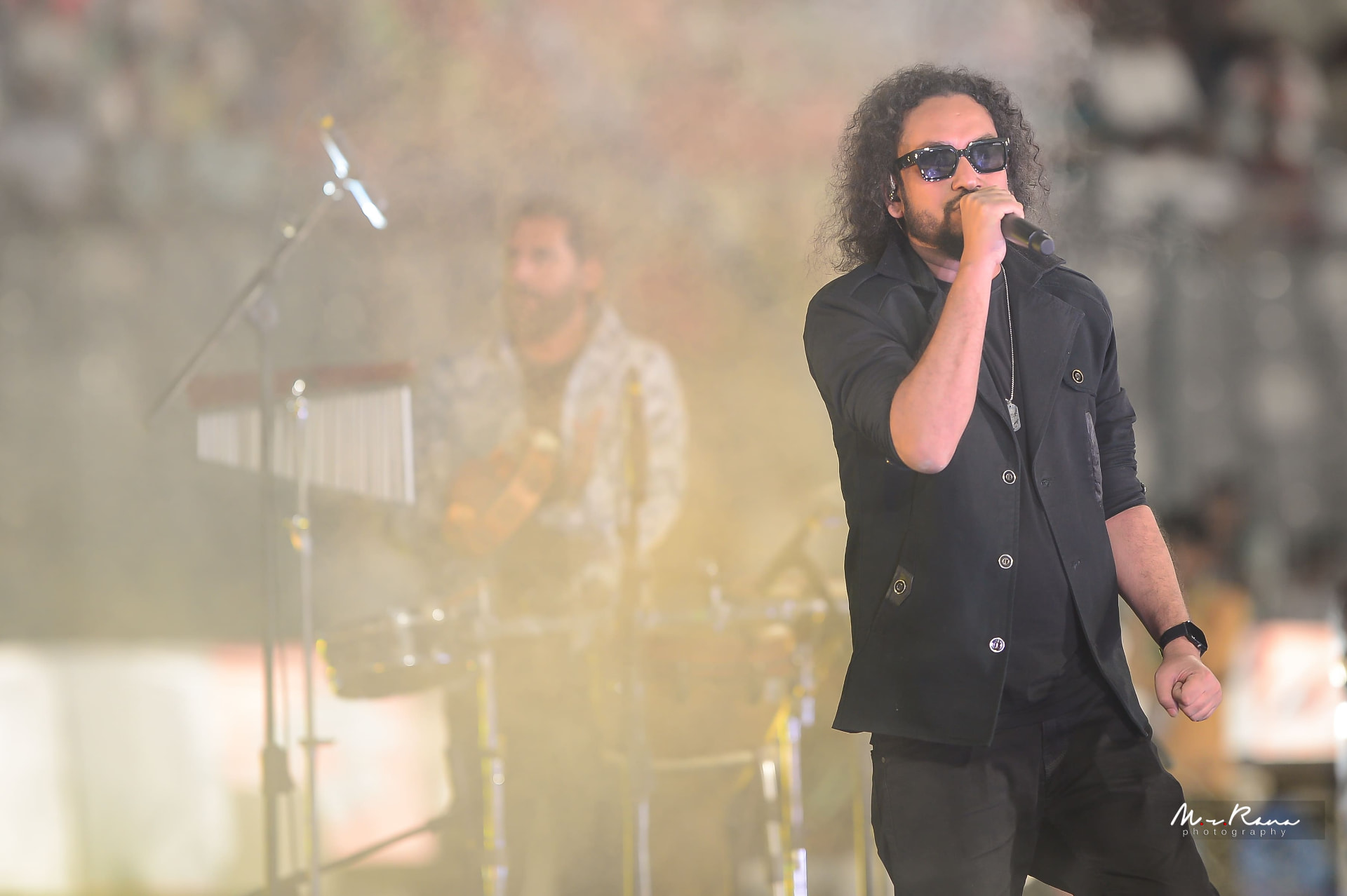 Muttaque Hasib singing through stage haze