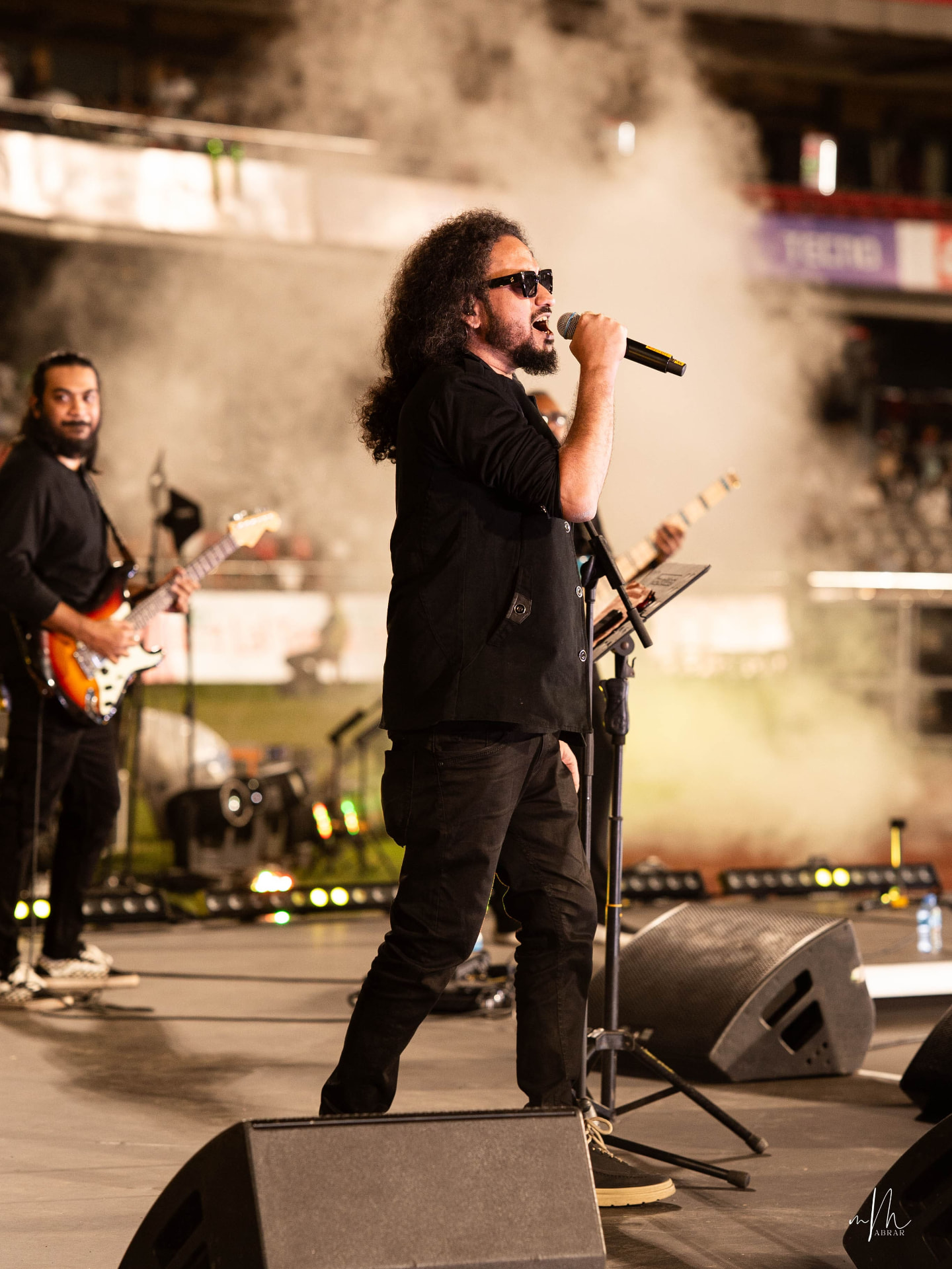 Muttaque Hasib at the microphone stand with his guitarist