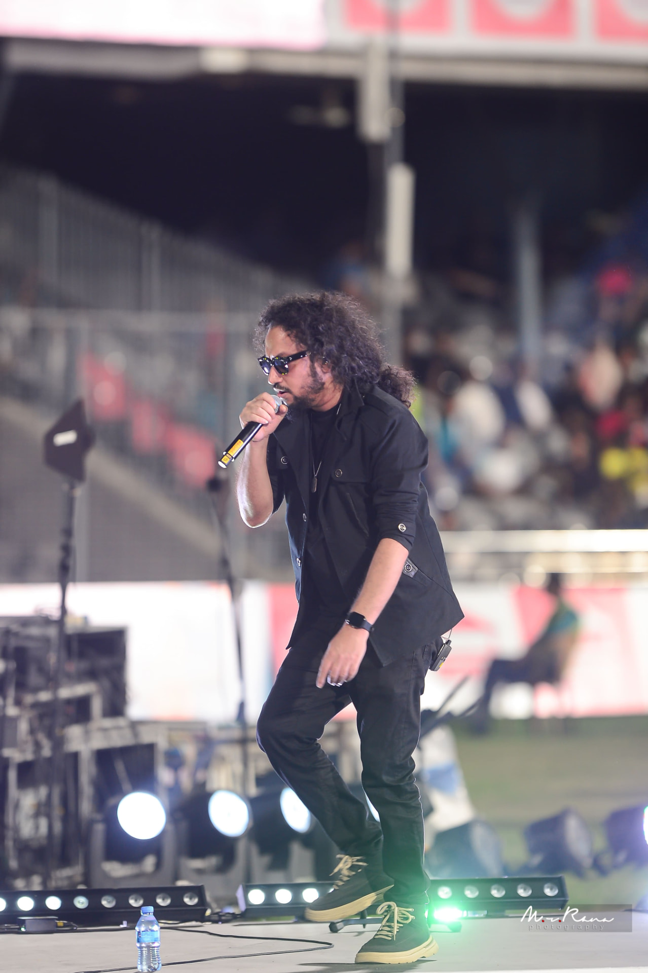 Muttaque Hasib moving across the stage while singing